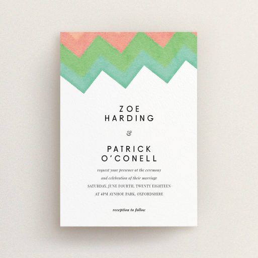 A personalised wedding invite named "Vibrant Peaks". It is an A6 invite in a portrait orientation. "Vibrant Peaks" is available as a flat invite, with tones of white, orange and green.
