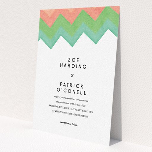 A personalised wedding invite named 'Vibrant Peaks'. It is an A6 invite in a portrait orientation. 'Vibrant Peaks' is available as a flat invite, with tones of white, orange and green.