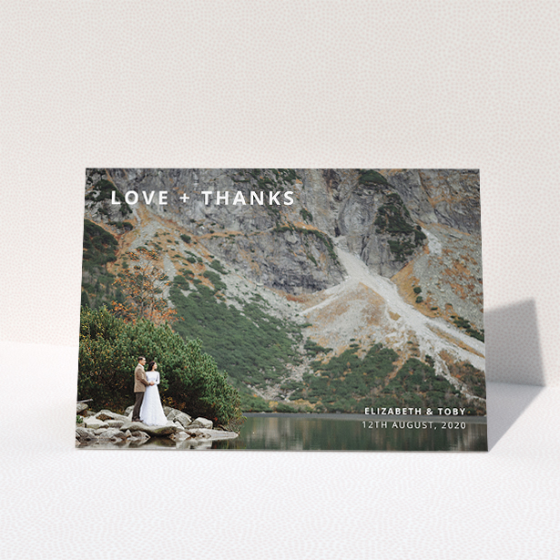 A photo wedding thank you card design titled "Love and Thanks Landscape". It is an A5 card in a landscape orientation. It is a photographic photo wedding thank you card with room for 1 photo. "Love and Thanks Landscape" is available as a folded card, with mainly white colouring.