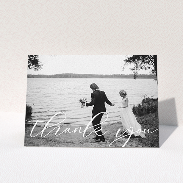 A photo wedding thank you card design named "One Photo". It is an A6 card in a landscape orientation. It is a photographic photo wedding thank you card with room for 1 photo. "One Photo" is available as a folded card, with mainly white colouring.