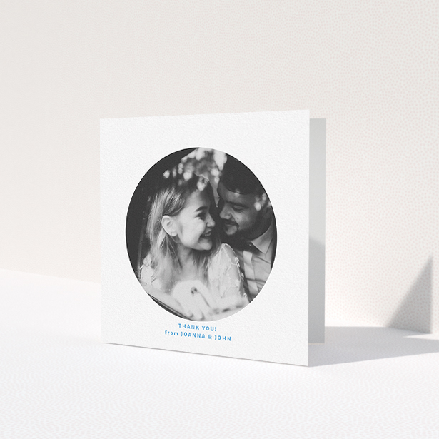 A photo wedding thank you card design titled 'Photo hole'. It is a square (148mm x 148mm) card in a square orientation. It is a photographic photo wedding thank you card with room for 1 photo. 'Photo hole' is available as a folded card, with tones of white and blue.