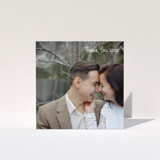 A photo wedding thank you card design named "Thank You XOXO". It is a square (148mm x 148mm) card in a square orientation. It is a photographic photo wedding thank you card with room for 1 photo. "Thank You XOXO" is available as a folded card, with mainly white colouring.