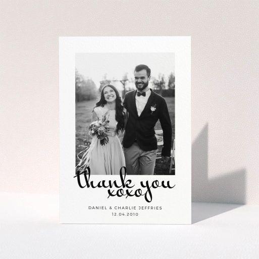 A photo wedding thank you card design named "XoXo". It is an A5 card in a portrait orientation. It is a photographic photo wedding thank you card with room for 1 photo. "XoXo" is available as a folded card, with mainly white colouring.