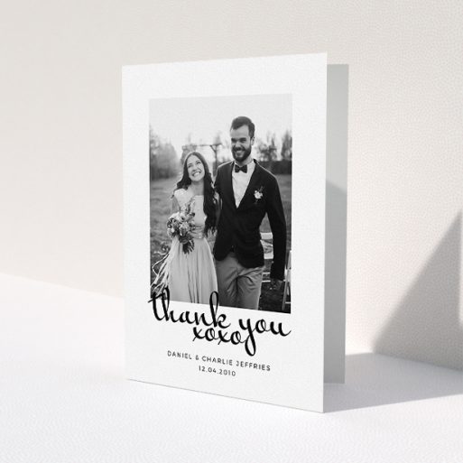 A photo wedding thank you card design named 'XoXo'. It is an A5 card in a portrait orientation. It is a photographic photo wedding thank you card with room for 1 photo. 'XoXo' is available as a folded card, with mainly white colouring.