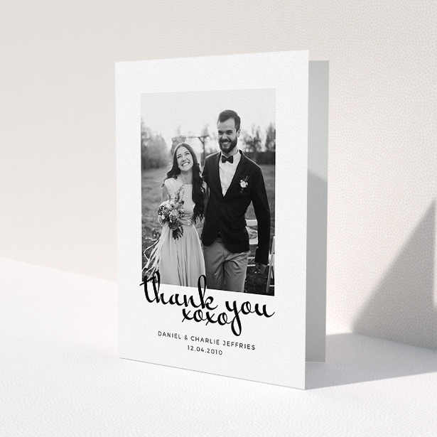 A photo wedding thank you card design named "XoXo". It is an A5 card in a portrait orientation. It is a photographic photo wedding thank you card with room for 1 photo. "XoXo" is available as a folded card, with mainly white colouring.