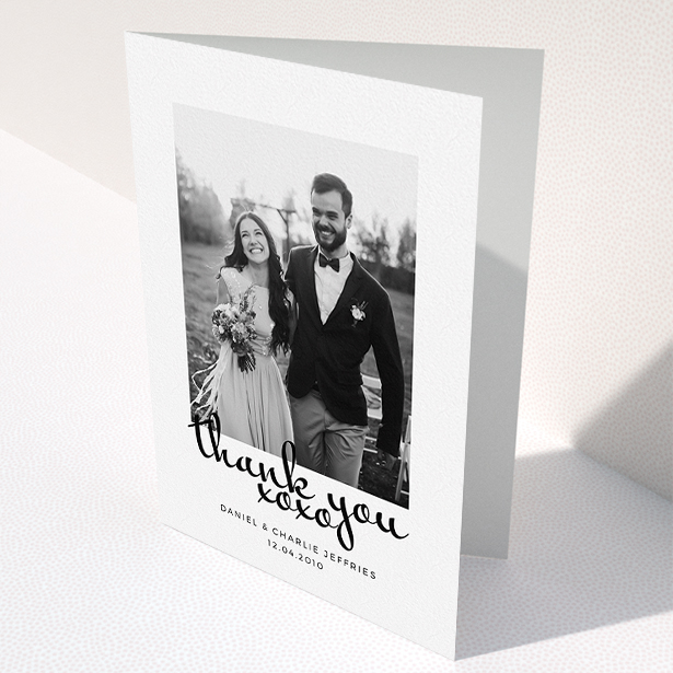 A photo wedding thank you card design named "XoXo". It is an A5 card in a portrait orientation. It is a photographic photo wedding thank you card with room for 1 photo. "XoXo" is available as a folded card, with mainly white colouring.