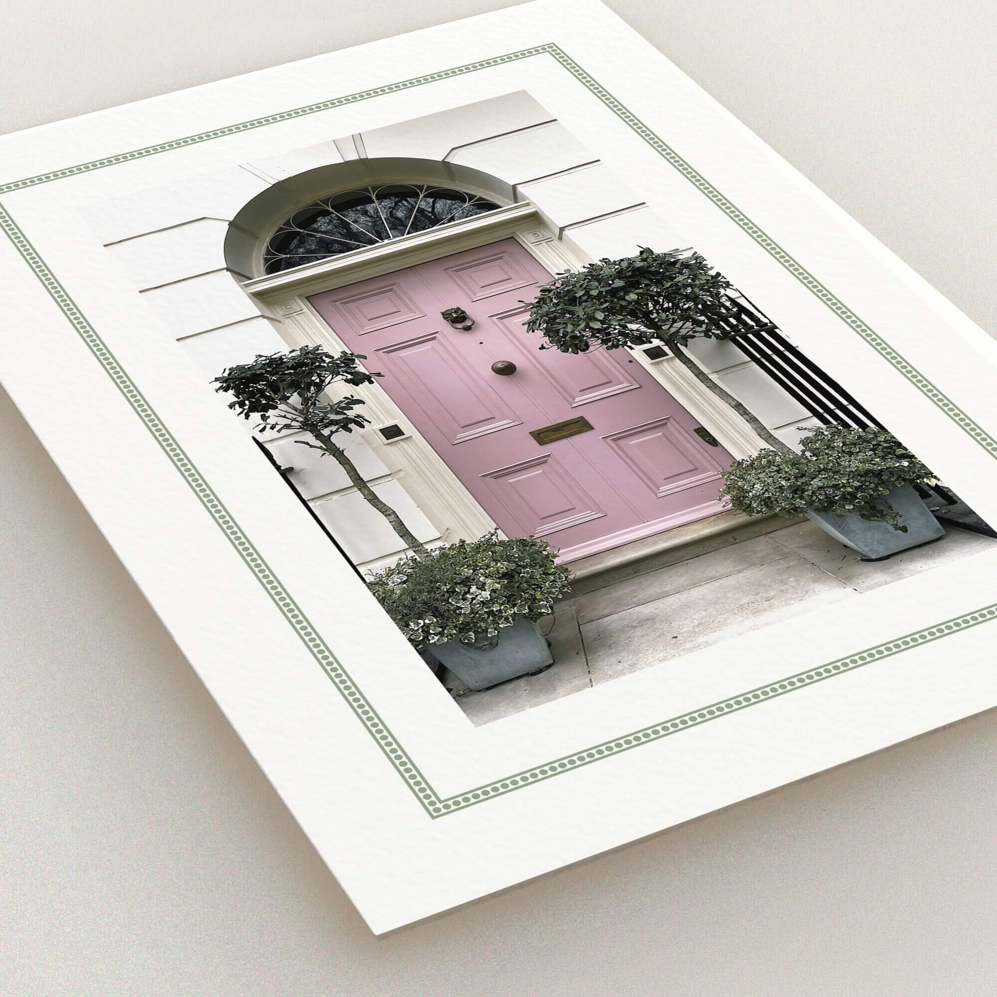 Change of address card featuring a stylish pink front door with two potted plants.