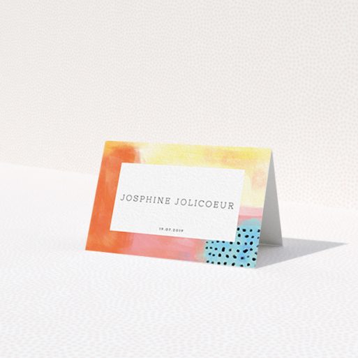 A place setting card template titled 'Abstract Colours'. It is an 85 x 55mm card in a landscape orientation. 'Abstract Colours' is available as a folded card, with tones of orange, red and yellow.