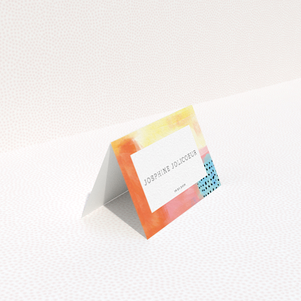 A place setting card template titled "Abstract Colours". It is an 85 x 55mm card in a landscape orientation. "Abstract Colours" is available as a folded card, with tones of orange, red and yellow.