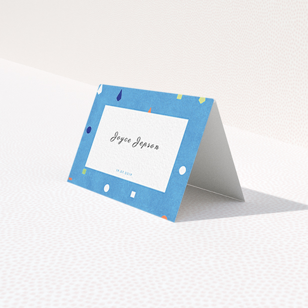 A place setting card named "Capri". It is an 85 x 55mm card in a landscape orientation. "Capri" is available as a folded card, with tones of light blue and orange.