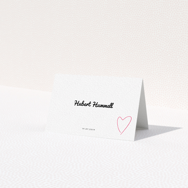 A place setting card design called 'Casual Loving'. It is an 85 x 55mm card in a landscape orientation. 'Casual Loving' is available as a folded card, with tones of white and pink.