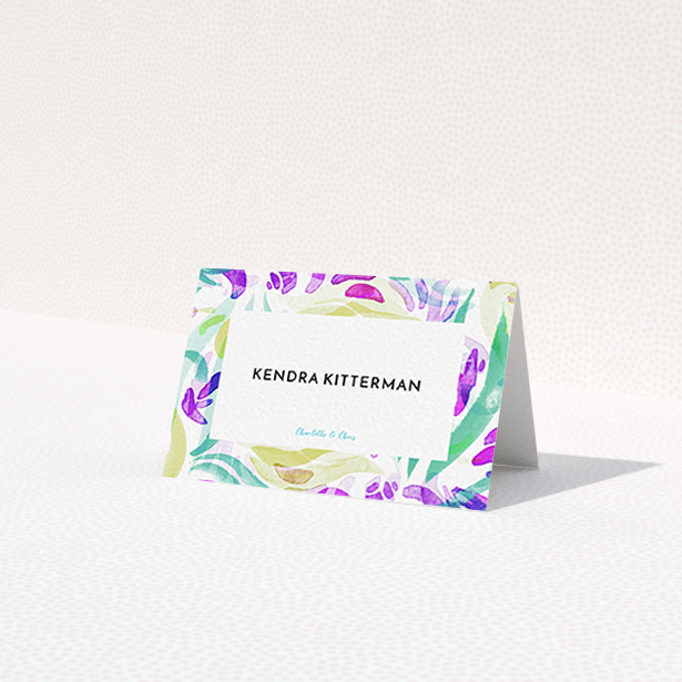 A place setting card design titled "Neon Florals". It is an 85 x 55mm card in a landscape orientation. "Neon Florals" is available as a folded card, with tones of white, green and pink.