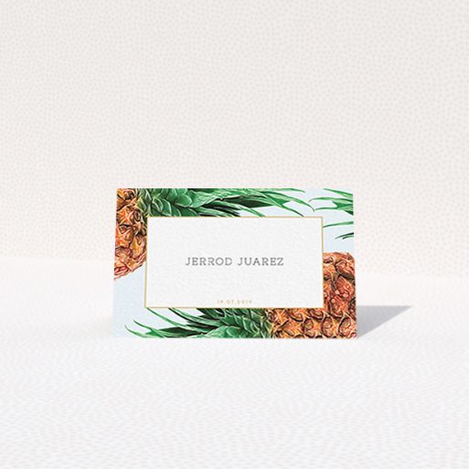 A place setting card called "Pineapples falling". It is an 85 x 55mm card in a landscape orientation. "Pineapples falling" is available as a folded card, with tones of green, green and brown.