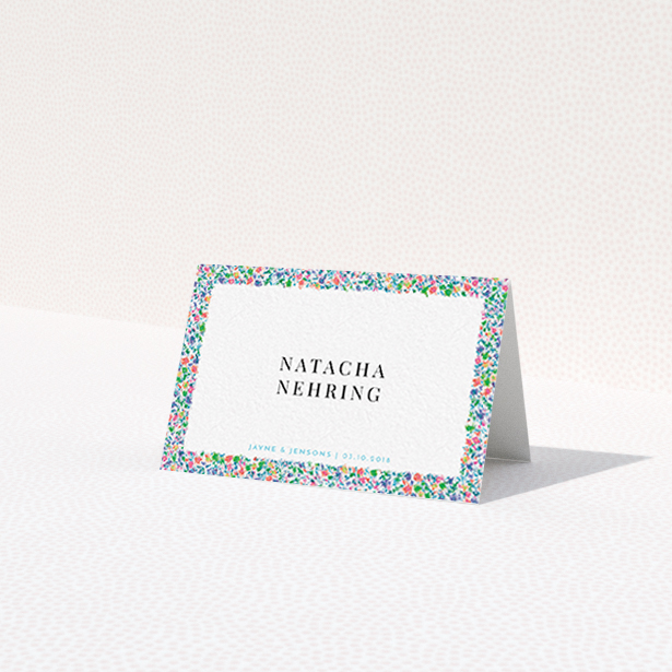 A place setting card design called "The faraway garden". It is an 85 x 55mm card in a landscape orientation. "The faraway garden" is available as a folded card, with tones of green, blue and red.