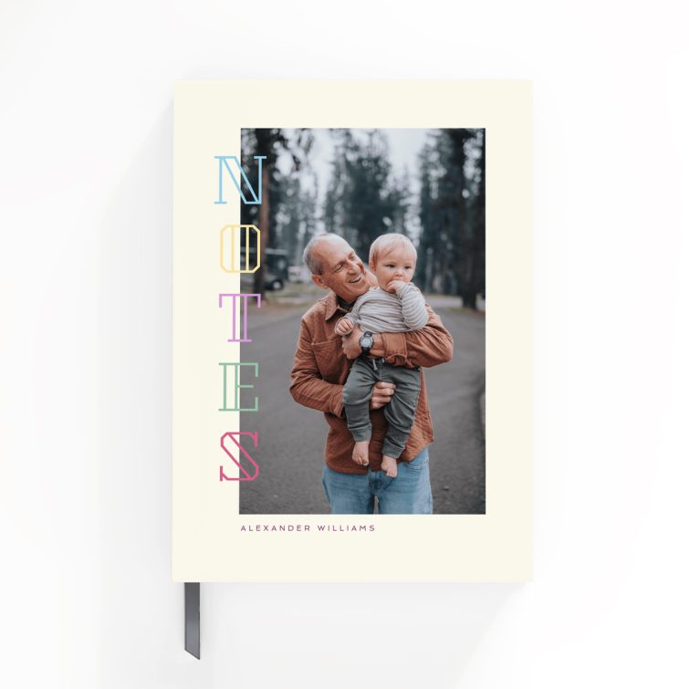 Portrait notebook cover design with colourful vertical text and one photo on the front cover.