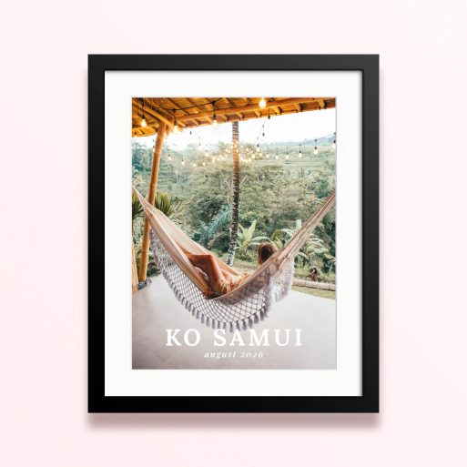 Framed and mounted photo print with one photo of a woman relaxing in a hammock on a tropical terrace, decorated with hanging lights, with text "Ko Samui August 2026".