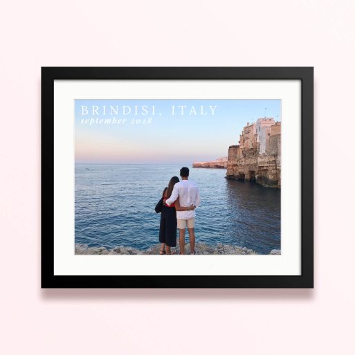 Framed and mounted photo print of a couple by the sea with cliffs in the background and text overlay.