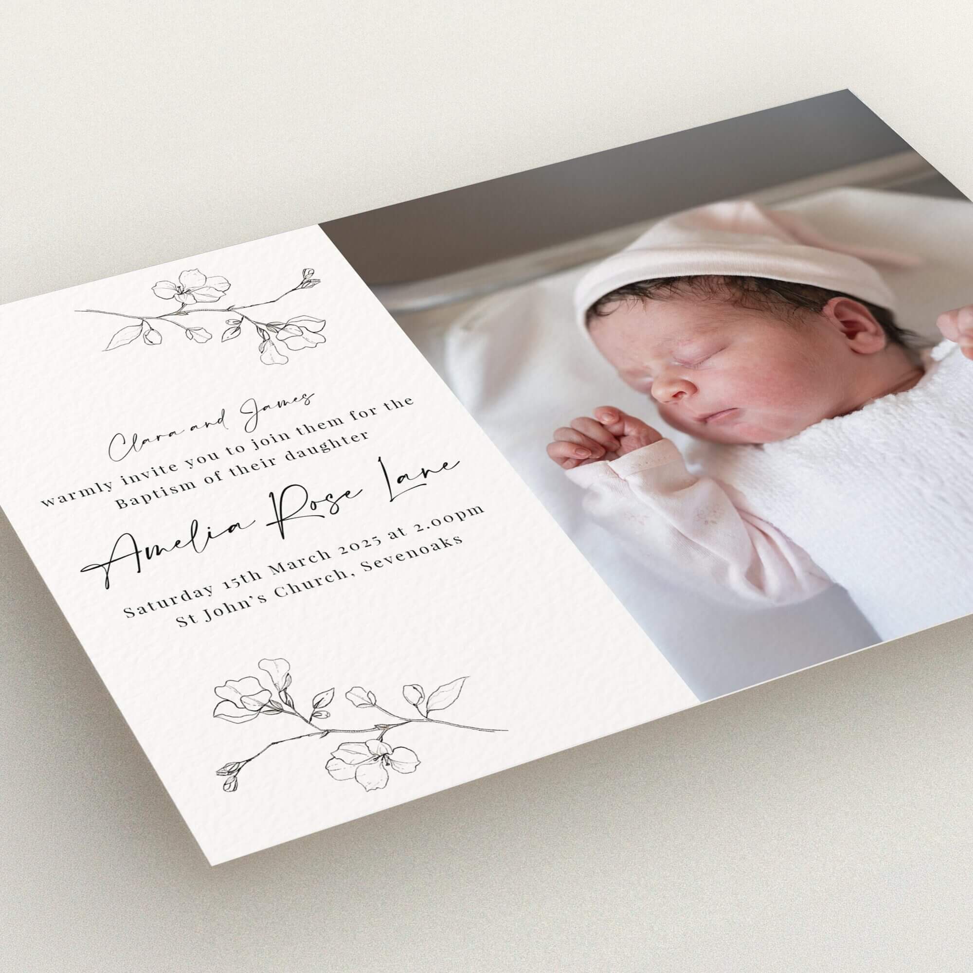 Christening invitation design with floral accents and one photo of a baby.