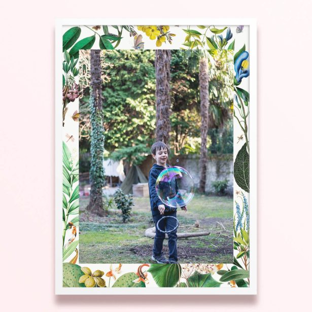 Simple framed print design with floral borders and one photo of a child playing outdoors