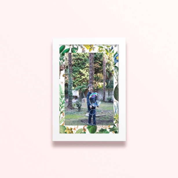Simple framed print design with floral borders and one photo of a child playing outdoors