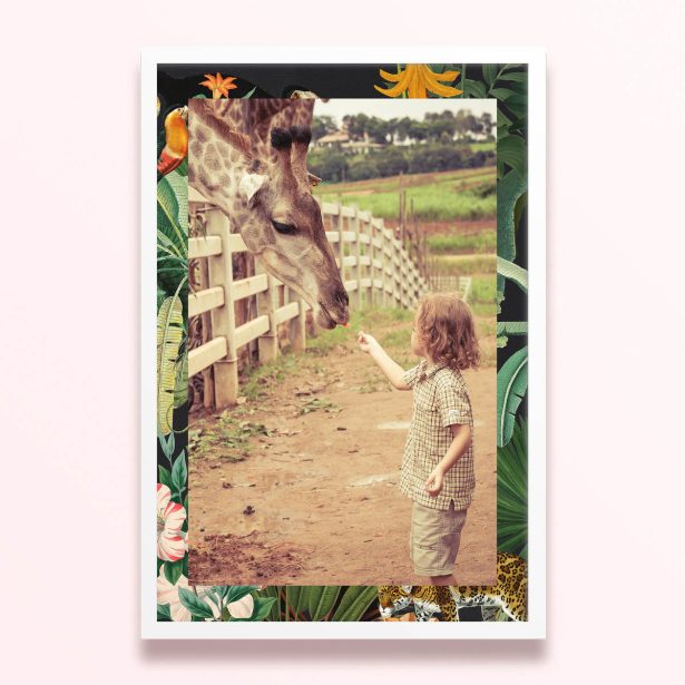 Simple framed prints design with one photo of a child feeding a giraffe, surrounded by a floral and jungle-themed border.