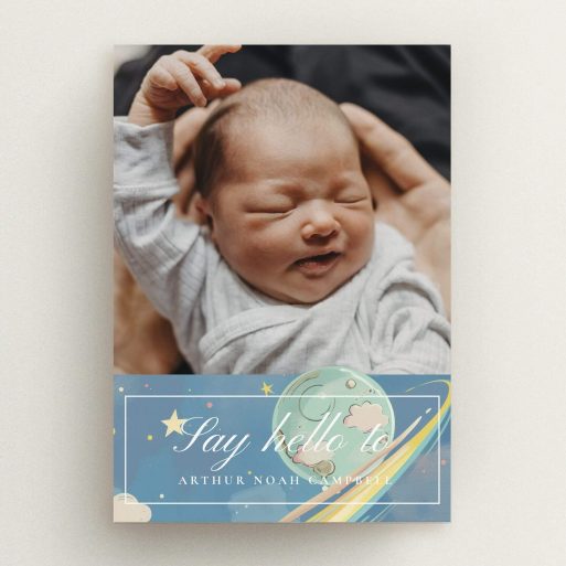 Birth announcement card with one photo of a newborn in arms and decorative celestial design