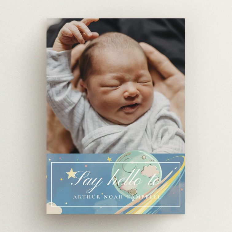 Birth announcement card with one photo of a newborn in arms and decorative celestial design