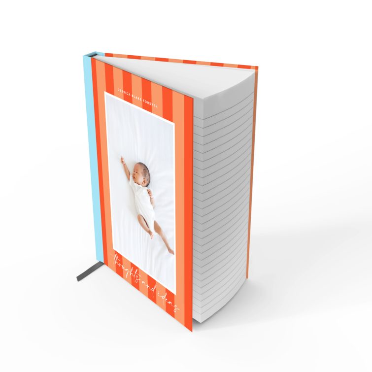 Portrait orientation notebook design with orange and blue striped cover and one photo of a baby.