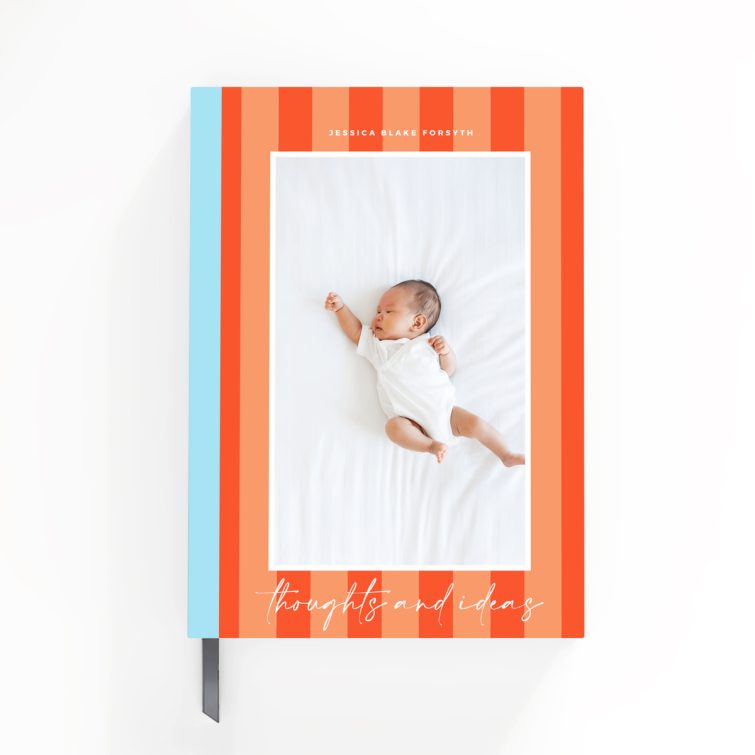 Portrait orientation notebook design with orange and blue striped cover and one photo of a baby.