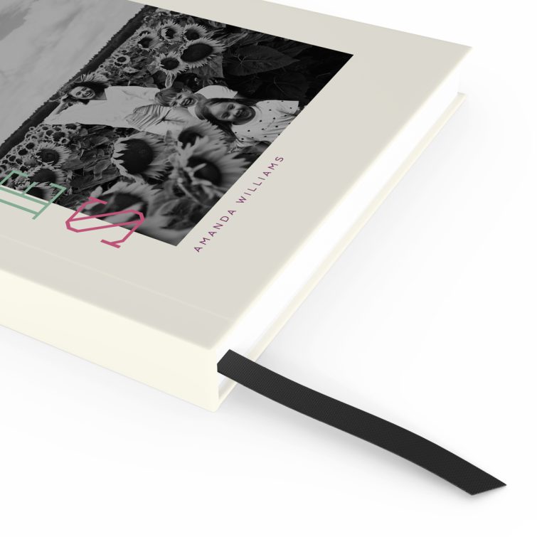 Modern black and white portrait notebook design with colourful text and one photo on the cover.