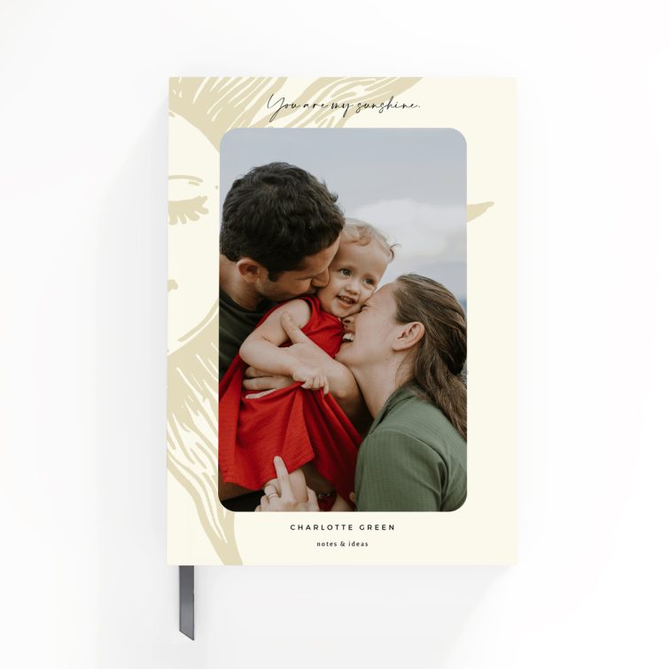 Portrait notebook design with a smiling sun illustration, featuring one photo on the front cover.