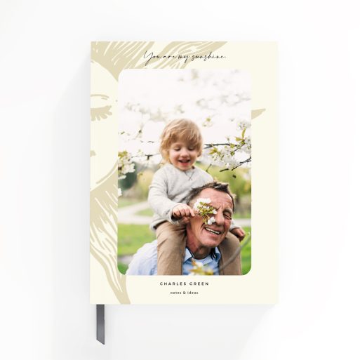 Notebook cover design with an illustrated sun and one photo on the front.