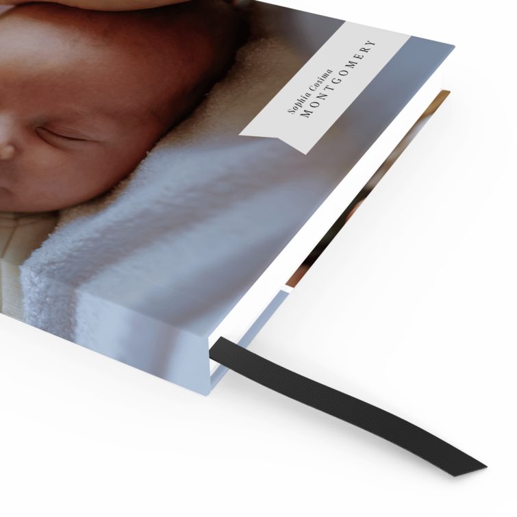 Personalised baby photo notebooks featuring four images, ideal for new parents.