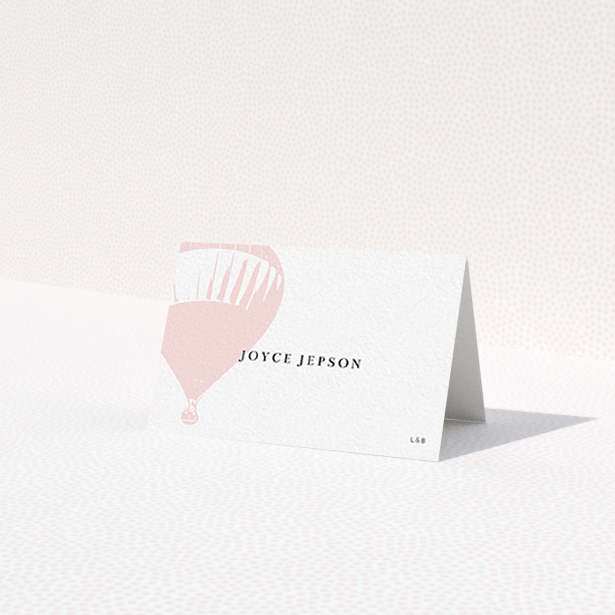 A table place card design named "Drifting Away". It is an 85 x 55mm card in a landscape orientation. "Drifting Away" is available as a folded card, with tones of pink and white.