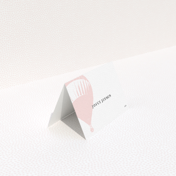 A table place card design named "Drifting Away". It is an 85 x 55mm card in a landscape orientation. "Drifting Away" is available as a folded card, with tones of pink and white.