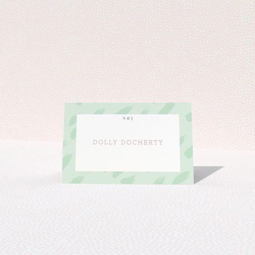 Table Place Card Design - "Green Strokes" A table place card named "Green Strokes". It is an 85 x 55mm card in a landscape orientation. "Green Strokes" is available as a folded card, with tones of green and white.