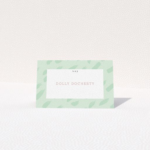 A table place card named "Green Strokes". It is an 85 x 55mm card in a landscape orientation. "Green Strokes" is available as a folded card, with tones of green and white.