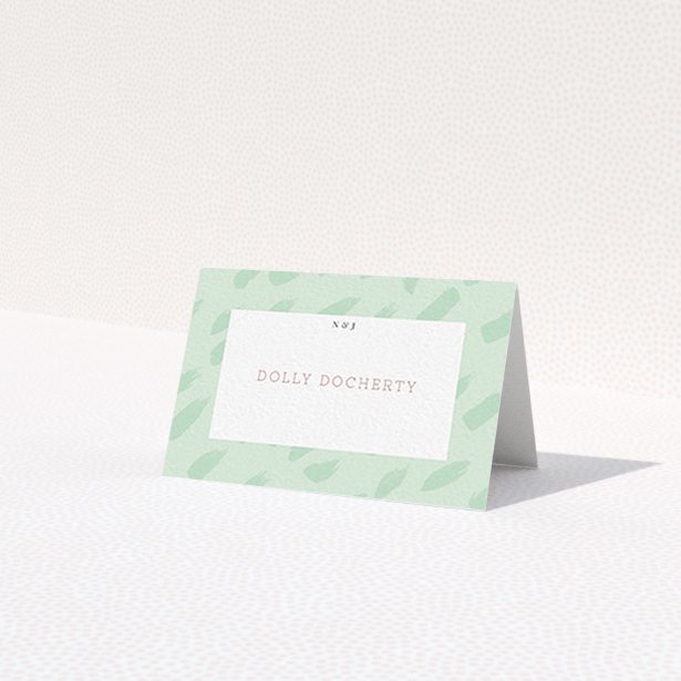 A table place card named 'Green Strokes'. It is an 85 x 55mm card in a landscape orientation. 'Green Strokes' is available as a folded card, with tones of green and white.