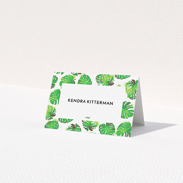 A table place card design named 'Jungle Sky'. It is an 85 x 55mm card in a landscape orientation. 'Jungle Sky' is available as a folded card, with tones of green and white.