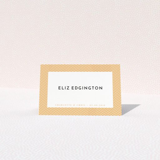 Table Place Card Design - "Orange Houndstooth" A table place card design titled "Orange Houndstooth". It is an 85 x 55mm card in a landscape orientation. "Orange Houndstooth" is available as a folded card, with tones of orange and white.