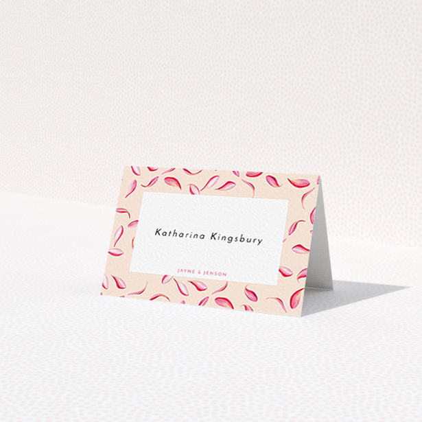 A table place card design named 'Petal avalanche'. It is an 85 x 55mm card in a landscape orientation. 'Petal avalanche' is available as a folded card, with tones of pink, red and white.