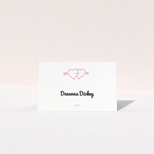 Table Place Card Design - "Shot to the Hearts" A table place card named "Shot to the Hearts". It is an 85 x 55mm card in a landscape orientation. "Shot to the Hearts" is available as a folded card, with tones of white and pink.