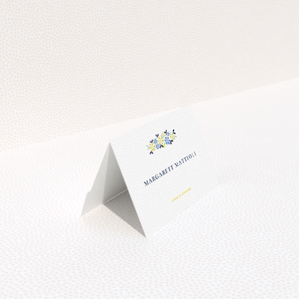 A table place card template titled "Simplistic Bouquet". It is an 85 x 55mm card in a landscape orientation. "Simplistic Bouquet" is available as a folded card, with tones of white and blue.
