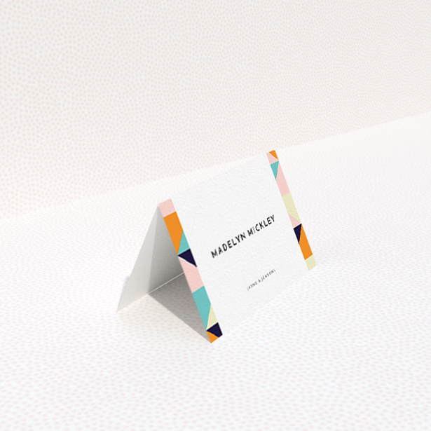 A table place card called "Sloane Squares". It is an 85 x 55mm card in a landscape orientation. "Sloane Squares" is available as a folded card, with mainly orange colouring.