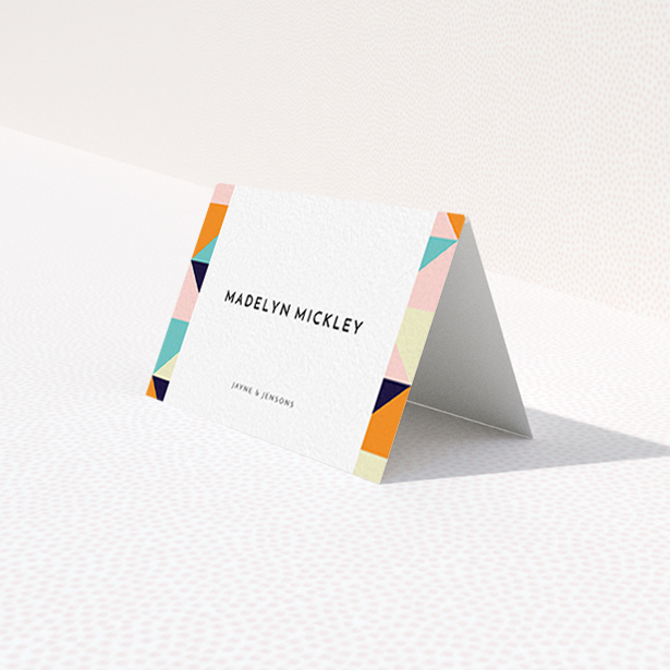 A table place card called "Sloane Squares". It is an 85 x 55mm card in a landscape orientation. "Sloane Squares" is available as a folded card, with mainly orange colouring.
