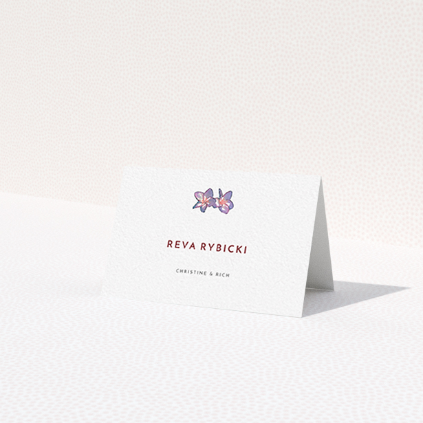 A table place card template titled 'Two little Orchids'. It is an 85 x 55mm card in a landscape orientation. 'Two little Orchids' is available as a folded card, with tones of white and purple.