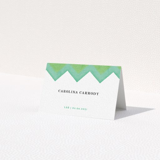 A table place card named 'Vibrant Peaks'. It is an 85 x 55mm card in a landscape orientation. 'Vibrant Peaks' is available as a folded card, with tones of green and white.