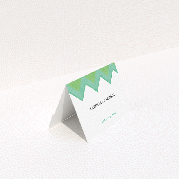 A table place card named "Vibrant Peaks". It is an 85 x 55mm card in a landscape orientation. "Vibrant Peaks" is available as a folded card, with tones of green and white.
