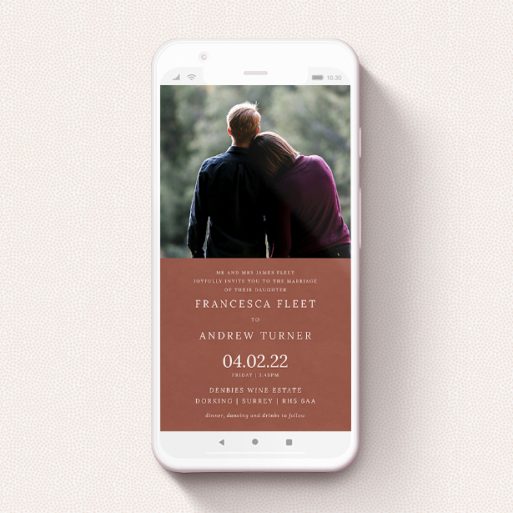 A text message wedding invite design titled "Autumnal Photo". It is a smartphone screen sized invite in a portrait orientation. It is a photographic text message wedding invite with room for 1 photo. "Autumnal Photo" is available as a flat invite, with mainly dark orange colouring.