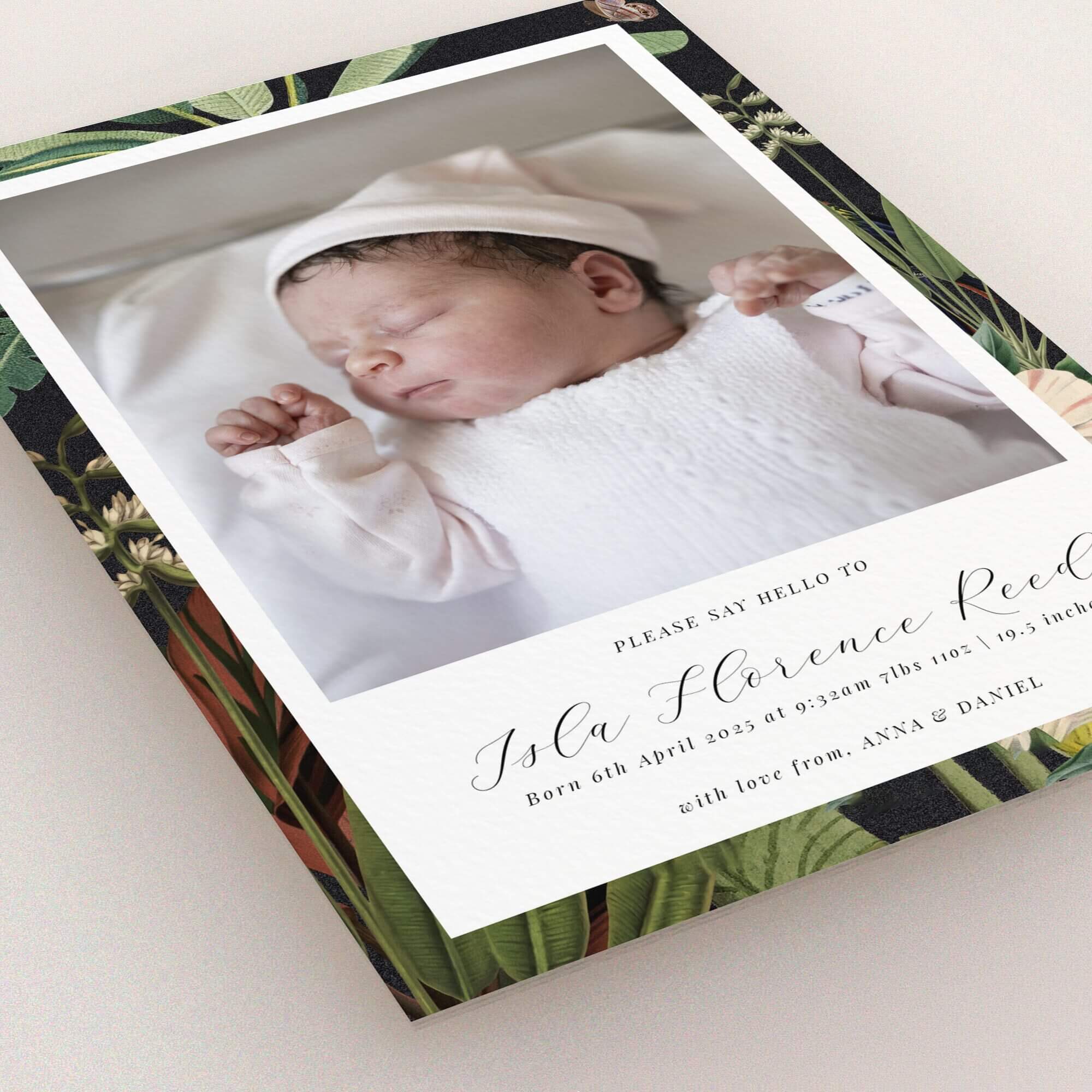 Birth announcement card design featuring a photo of a newborn baby with floral border.
